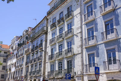 Low angle view of buildings against clear blue sky