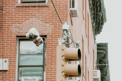 Low angle view of electric lamp on wall