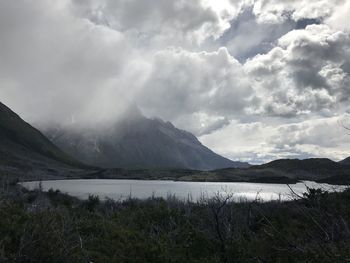 Scenic view of lake and mountains against sky