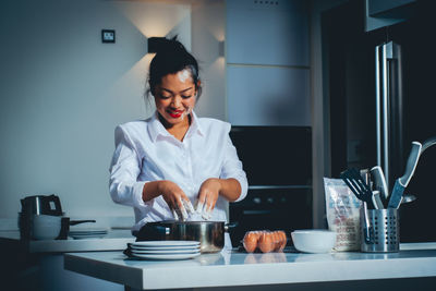 Woman working with food on table