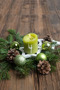 Close-up of lit candle on wreath