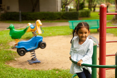 Girl playing on slide at playground