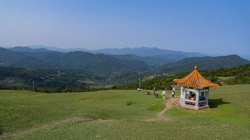 Traditional windmill on field against sky