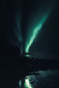 Scenic view of lake against sky at night