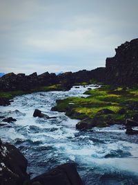 Scenic view of sea against cloudy sky