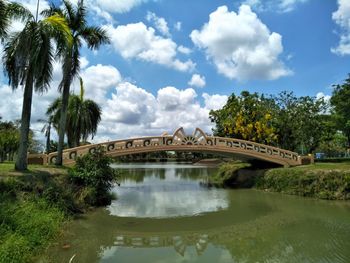 Arch bridge over river against sky