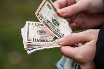 Close-up of hand holding paper