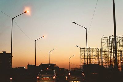 Traffic on road against sky at dusk