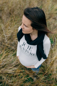 Pregnant woman standing on field