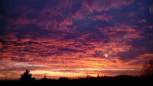 Silhouette of landscape against cloudy sky