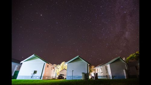 Houses against sky at night