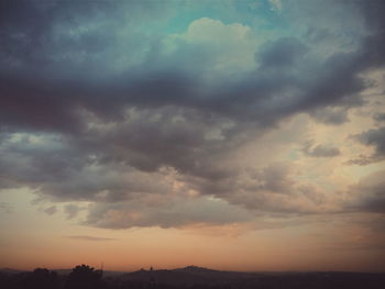 Low angle view of silhouette trees against sky