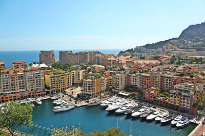 High angle view of yacht by buildings against sky