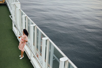 High angle view of woman standing against sea