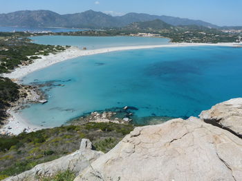 Scenic view of sea and mountains against sky