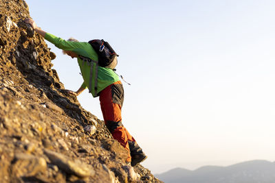 Senior man hiking a mountain during sunny day