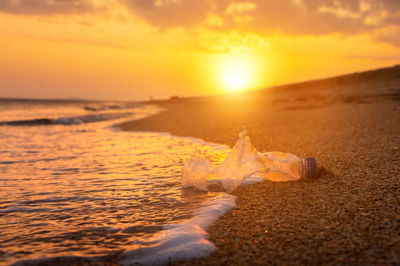 Scenic view of beach against sky during sunset