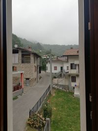 Buildings in city against sky during rainy season