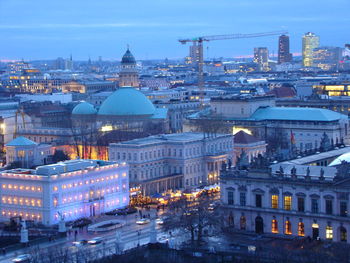 Illuminated buildings in city at dusk