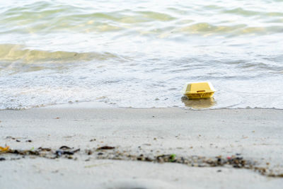 Yellow toy on beach