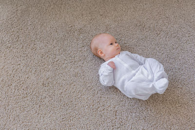 High angle view of baby girl lying on floor