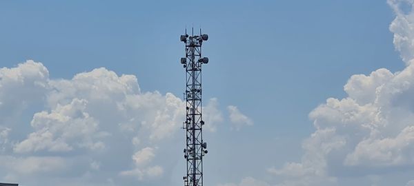 Low angle view of communications tower against sky