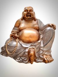 Close-up of buddha statue against white background