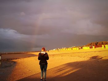 Rear view of man standing on beach