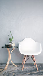 Potted plant on table against white wall