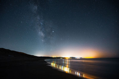 Scenic view of sea against sky at night