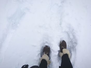 Low section of person standing on snow