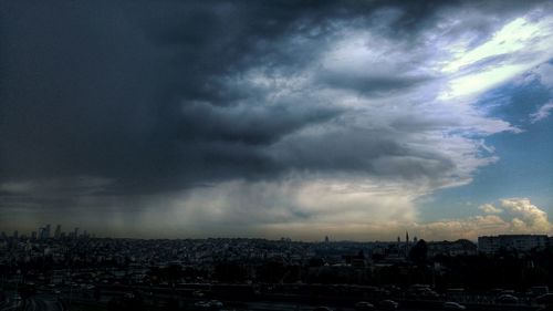 Cityscape against cloudy sky