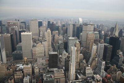 High angle view of modern buildings in city against sky