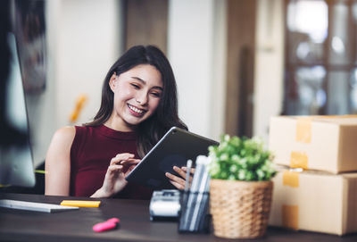 Woman working at home with laptop and mobile phone person