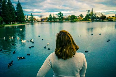 Young woman in front of lake