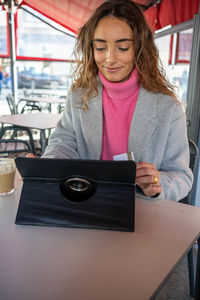 Portrait of young woman using mobile phone