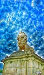 Low angle view of statue against blue sky