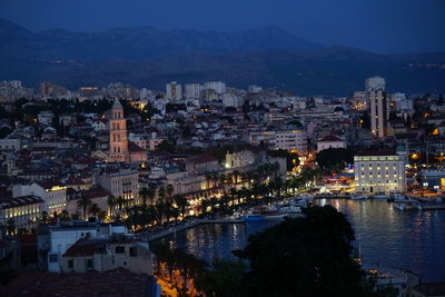 High angle view of illuminated buildings in city at dusk