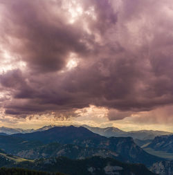 Scenic view of mountains against sky at sunset