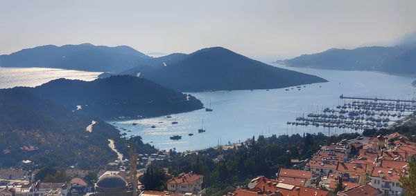 High angle view of townscape by mountains against sky