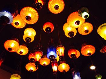 Low angle view of illuminated lanterns hanging at night