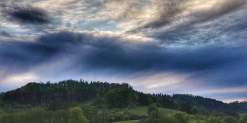 Scenic view of mountain against dramatic sky