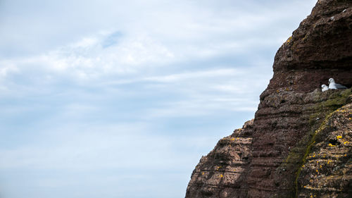 Low angle view of rock formation against sky