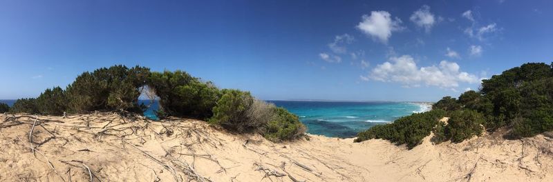 Panoramic view of sea against blue sky during sunny day