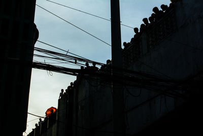 Low angle view of electricity pylon against sky