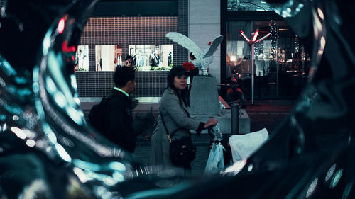 High angle view of man and woman standing at night