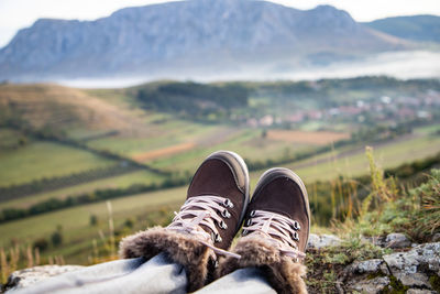 Low section of man relaxing on field