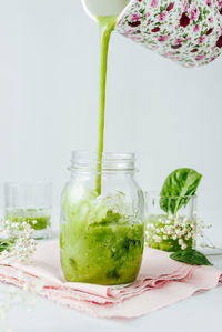 Close-up of drink in glass jar on table