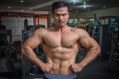 Portrait of shirtless man standing at home