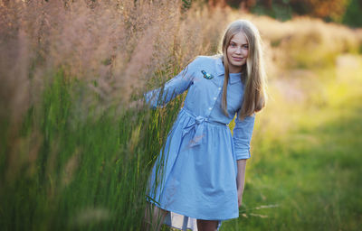 Teenage girl long blond hair on grass. pretty happy girl enjoying summer in park. beautiful model 